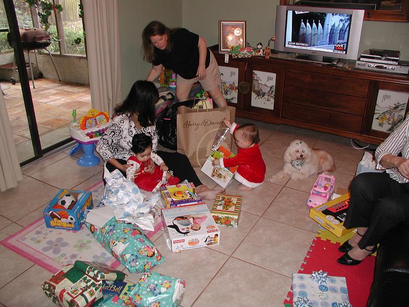 PC250090.JPG - Hannah is try to entice Rohan to the gifts.