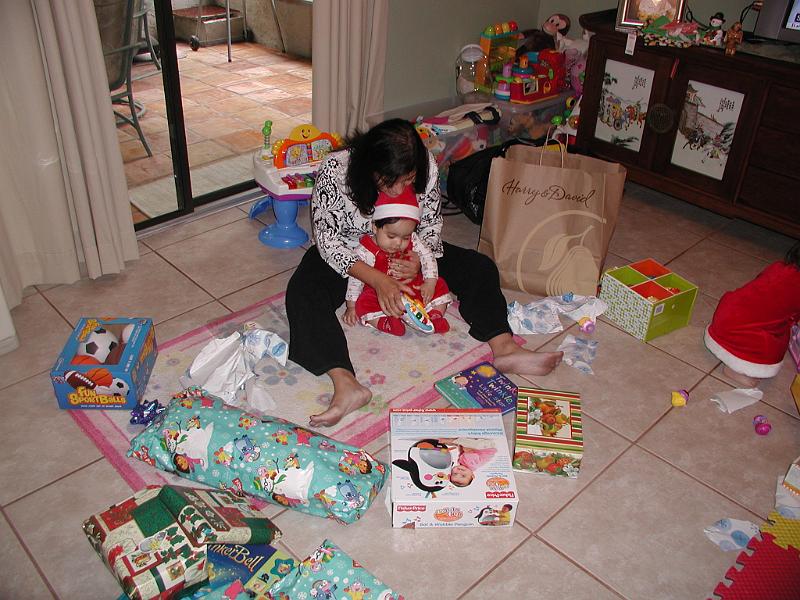 PC250091.JPG - Now his Mother is trying to teach Rohan - "The wrapping is unimportant - Look at what is inside"