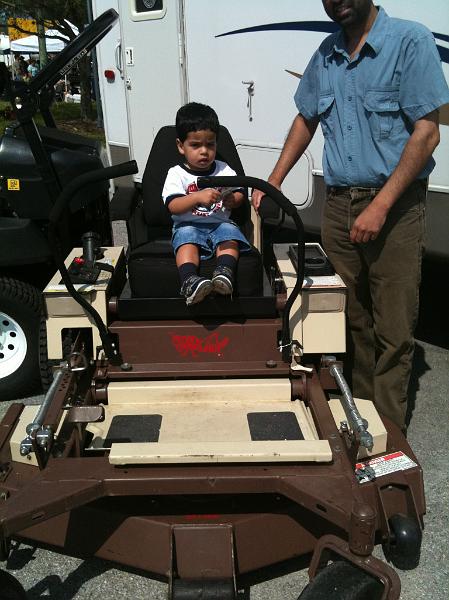 IMG_0060.JPG - Rohan in a riding lawn mower. This is what Rohan will get for his 5th birthday. He can cut all the lawns in the neighbourhood and pay for his boarding and lodging